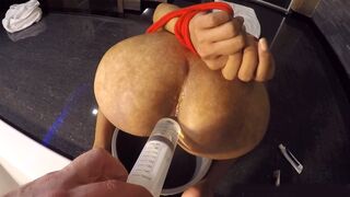 Pissing on big ass of an Asian ladyboy & filling it to squirt